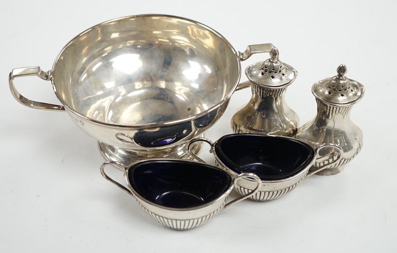 A George V silver two handled bowl and two pairs of early 20th century silver condiments. Condition - poor to fair